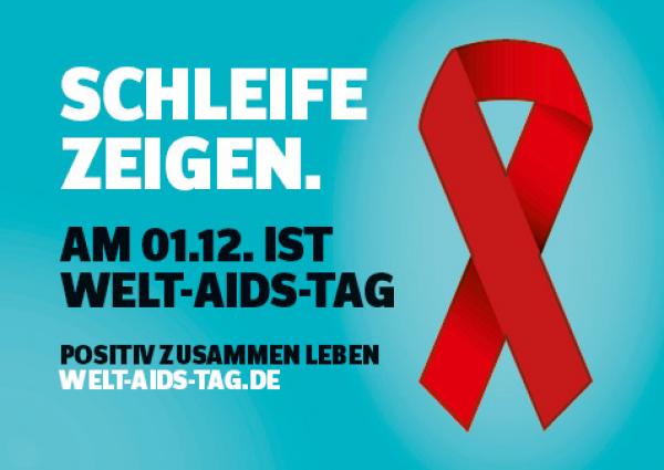 Welt-Aids-Tag 2021, Rote Schleife auf grübem Grund. Aufschrift "Schleife zeigen. am 01.12. ist Welt-Aids-Tag."