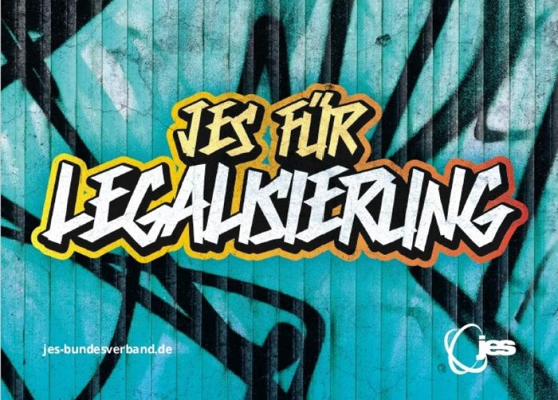 Graffiti mit dem Text "JES für Legalisierung" über einem anderen Graffiti gespüht